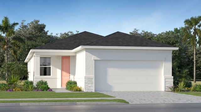 view of front of property with a front yard and a garage