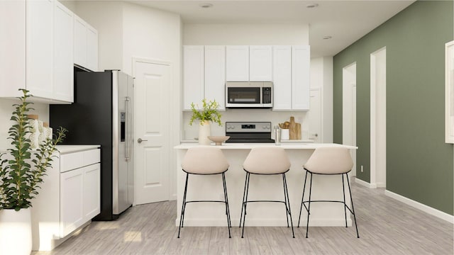 kitchen with white cabinets, stainless steel refrigerator with ice dispenser, electric range, and light hardwood / wood-style floors