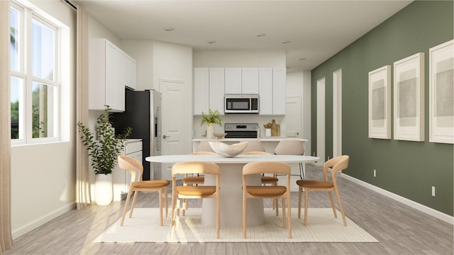 kitchen with light wood-style floors, a wealth of natural light, a center island, and stainless steel appliances
