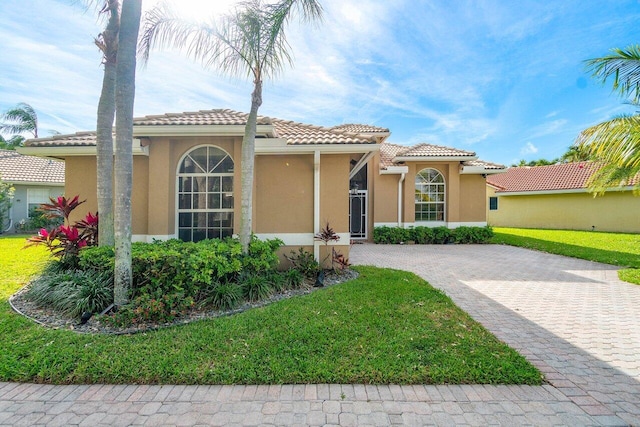 mediterranean / spanish house with a front lawn