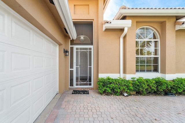 doorway to property with a garage