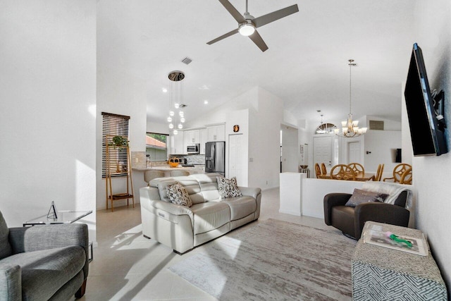 living room with ceiling fan with notable chandelier and high vaulted ceiling