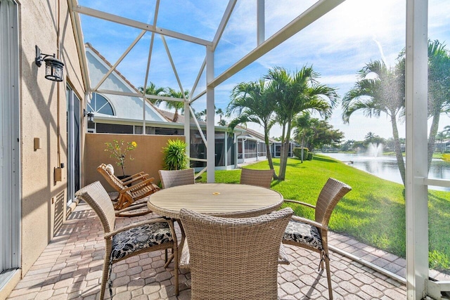 sunroom / solarium featuring a water view