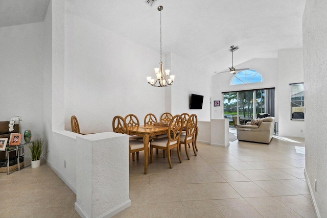 tiled dining space with ceiling fan with notable chandelier and high vaulted ceiling