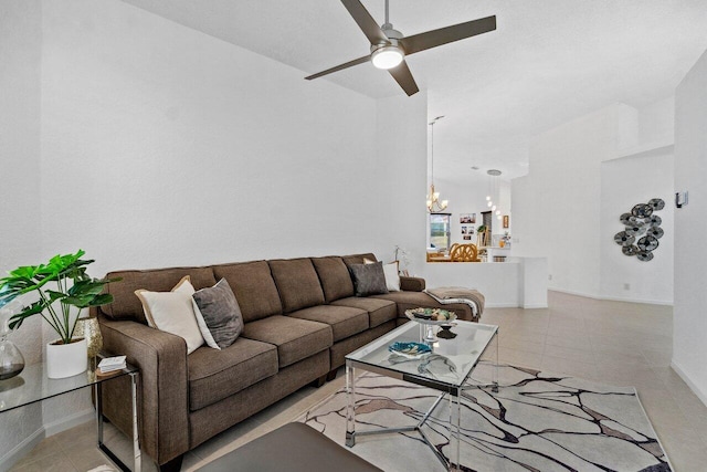 living room with light tile patterned flooring and ceiling fan with notable chandelier