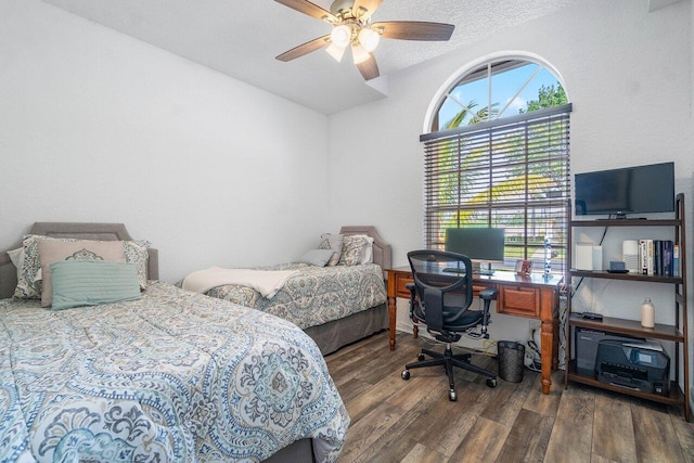 bedroom with dark hardwood / wood-style flooring and ceiling fan