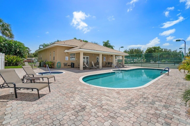 view of pool featuring a community hot tub, ceiling fan, and a patio area