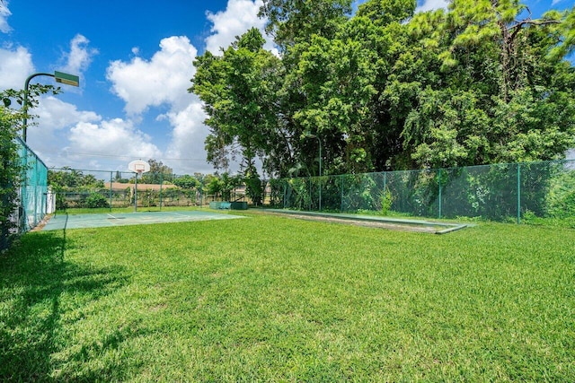 view of yard with basketball hoop