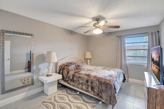 bedroom featuring a textured ceiling and ceiling fan