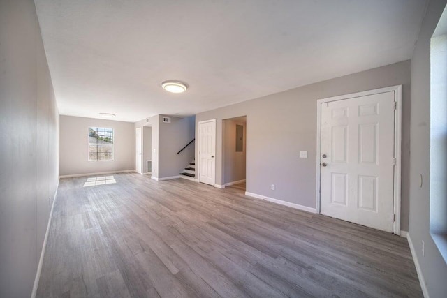 spare room with wood-type flooring and electric panel