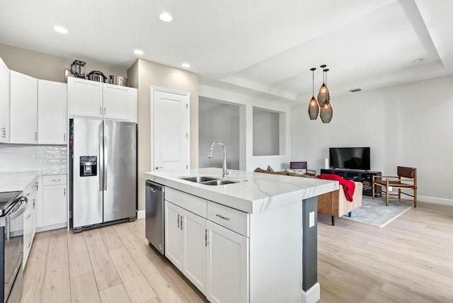 kitchen featuring white cabinets, sink, and appliances with stainless steel finishes