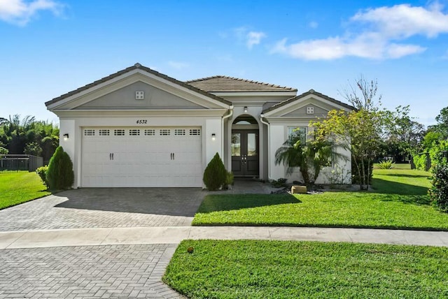 view of front facade featuring french doors, a front lawn, and a garage