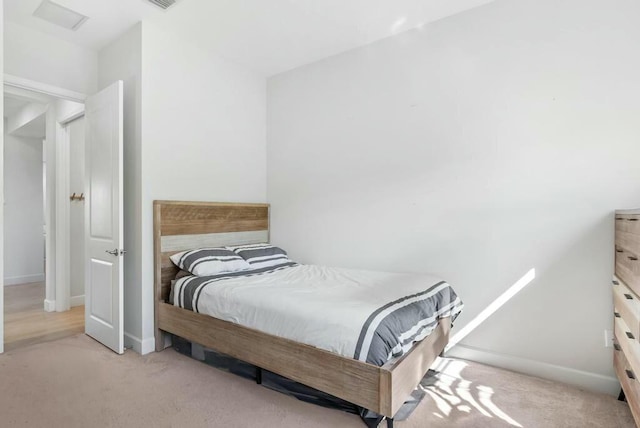 bedroom featuring light colored carpet