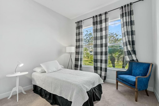 bedroom featuring light carpet