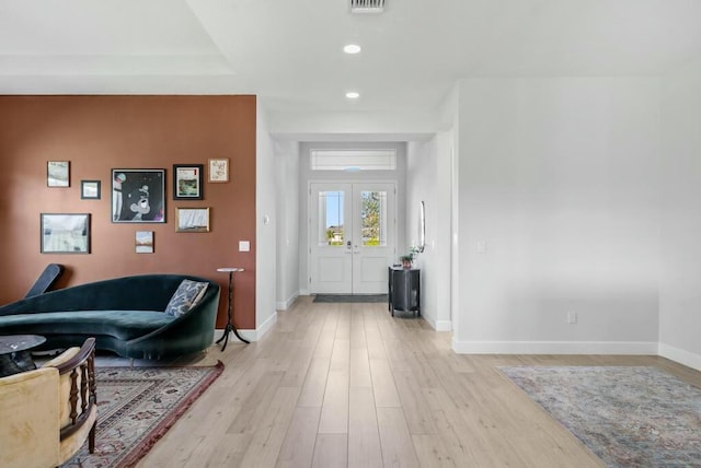 foyer featuring light hardwood / wood-style floors and french doors