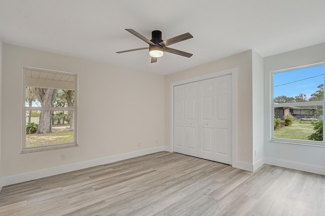 unfurnished bedroom featuring ceiling fan, a closet, and light hardwood / wood-style floors