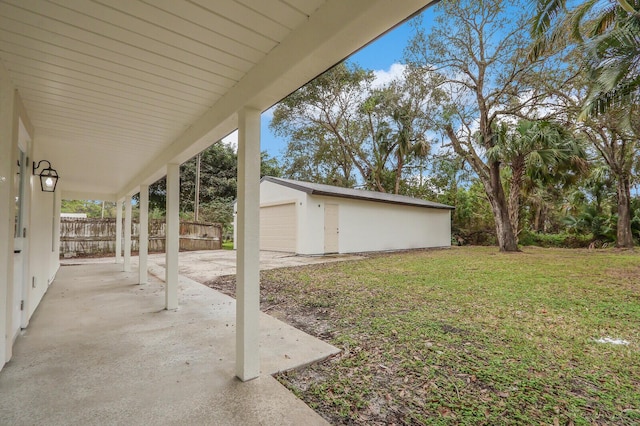 view of yard with a patio, an outdoor structure, and a garage