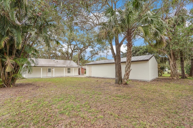 rear view of house featuring a lawn