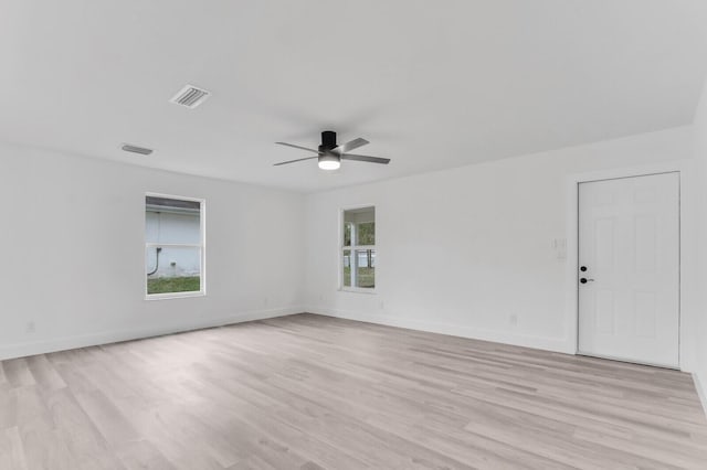 empty room featuring ceiling fan and light hardwood / wood-style floors