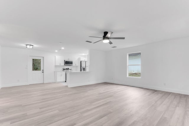 unfurnished living room featuring ceiling fan and light hardwood / wood-style flooring