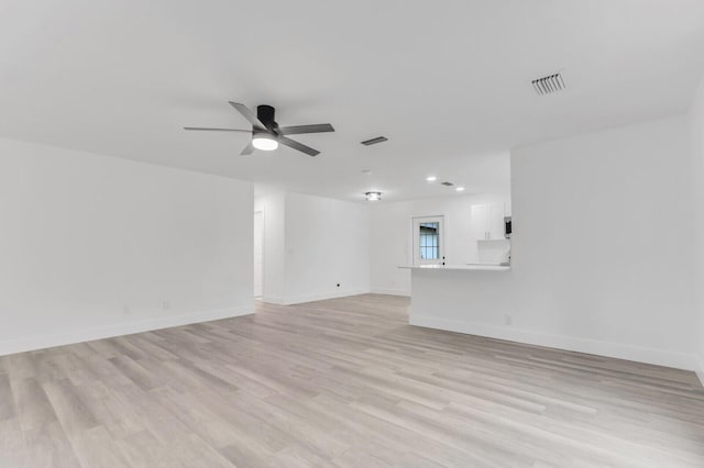 empty room with ceiling fan and light wood-type flooring