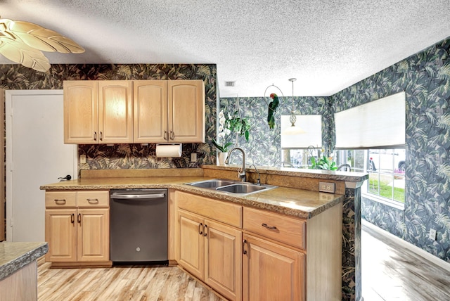 kitchen with light brown cabinetry, dishwasher, sink, and hanging light fixtures