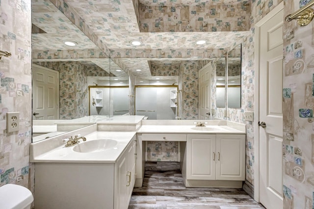 bathroom with vanity, toilet, and wood-type flooring