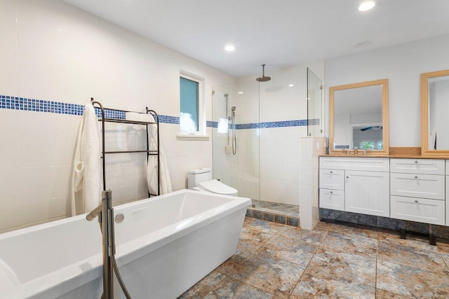 full bathroom featuring plus walk in shower, vanity, and toilet