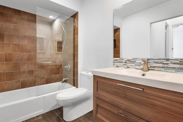 full bathroom with decorative backsplash, vanity, toilet, and tiled shower / bath