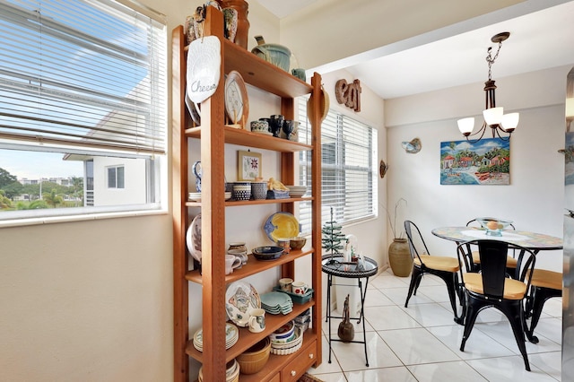 tiled dining space with a chandelier