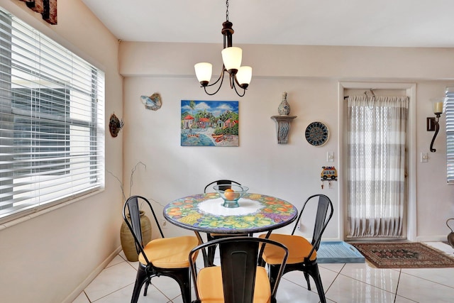 tiled dining space with a notable chandelier