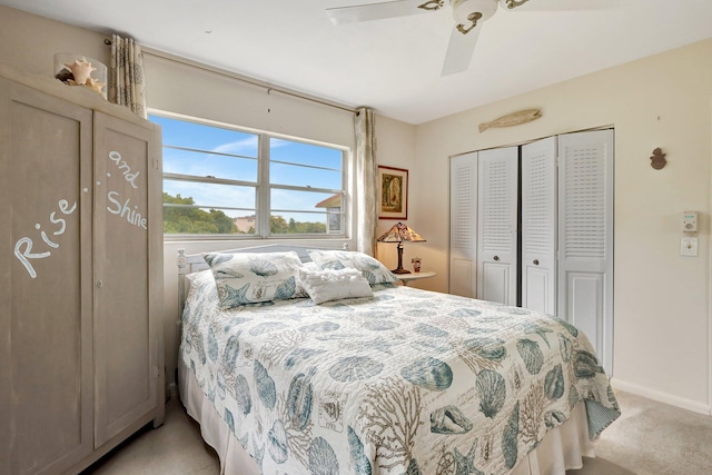 carpeted bedroom with ceiling fan and a closet