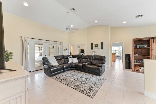 living room featuring light tile patterned floors, french doors, vaulted ceiling, and ceiling fan