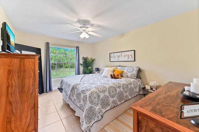 bedroom with ceiling fan and light tile patterned floors