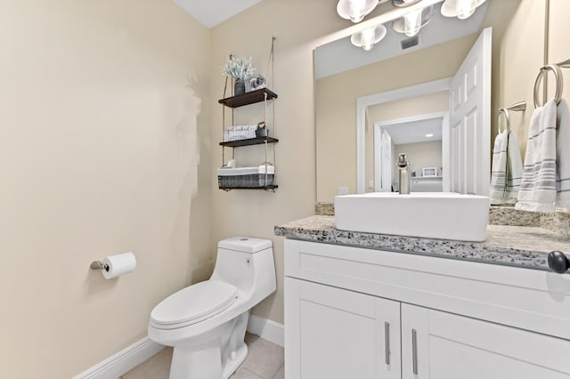 bathroom with tile patterned floors, vanity, and toilet