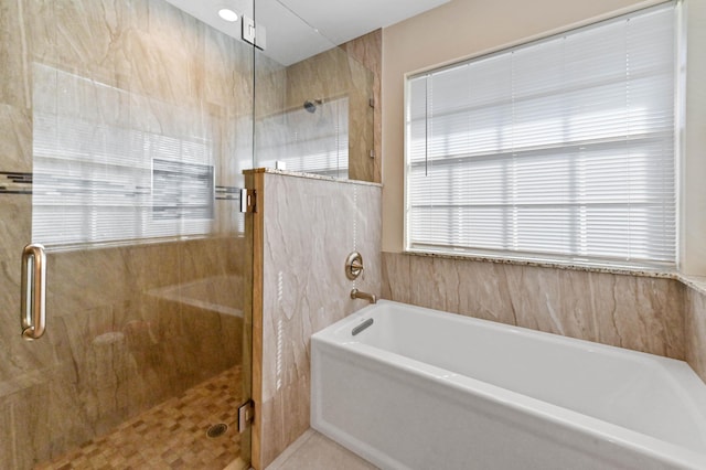 bathroom featuring plus walk in shower and tile patterned flooring