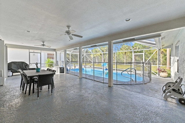 sunroom / solarium featuring ceiling fan and a swimming pool