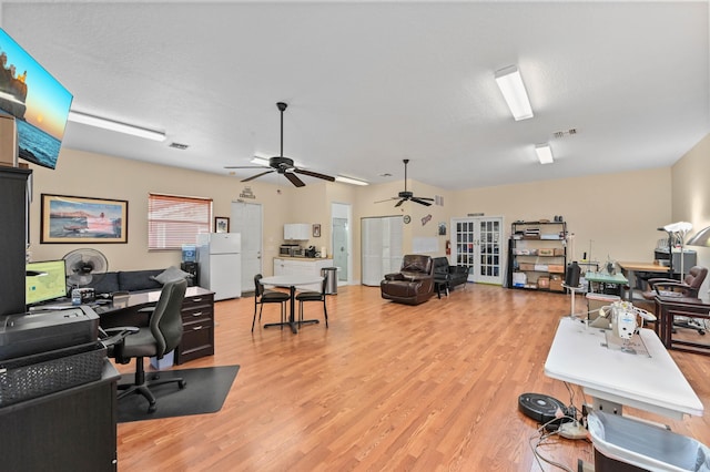 home office featuring light hardwood / wood-style flooring and a textured ceiling