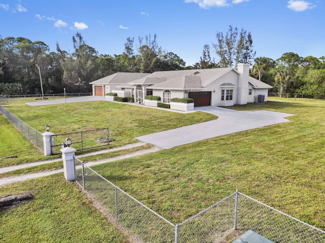 view of front of house featuring a garage and a front lawn