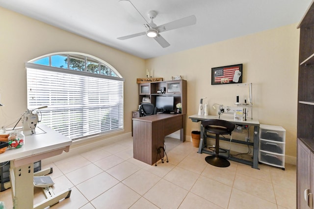 office area with light tile patterned floors and ceiling fan