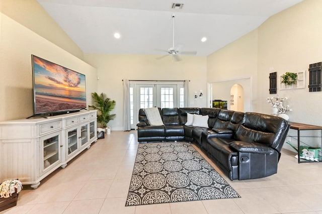 living room featuring ceiling fan, lofted ceiling, light tile patterned floors, and french doors