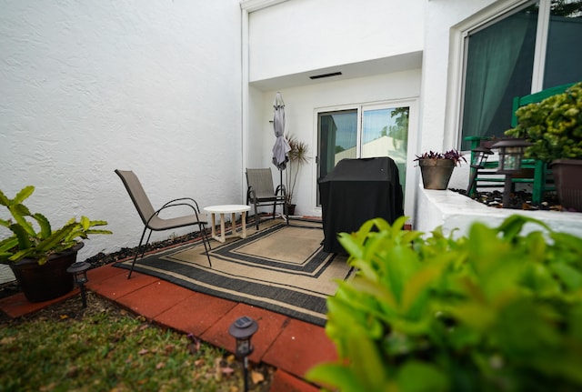 view of patio with visible vents and a grill