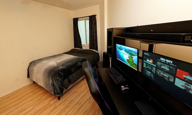 bedroom with wood finished floors and baseboards