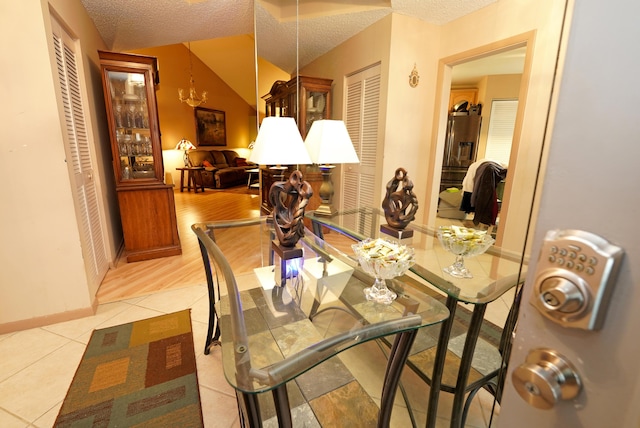 tiled dining room with a textured ceiling