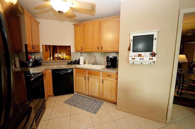 kitchen with a sink, backsplash, black appliances, and light tile patterned floors