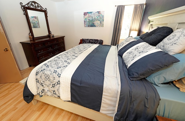 bedroom with hardwood / wood-style floors