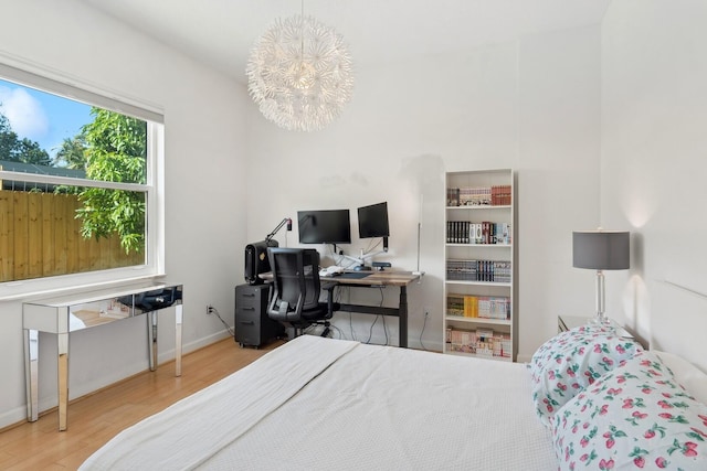 bedroom featuring hardwood / wood-style flooring and a chandelier