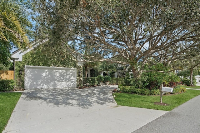 view of front of home featuring a front yard and a garage