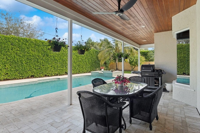 view of patio / terrace featuring a swimming pool with hot tub and ceiling fan