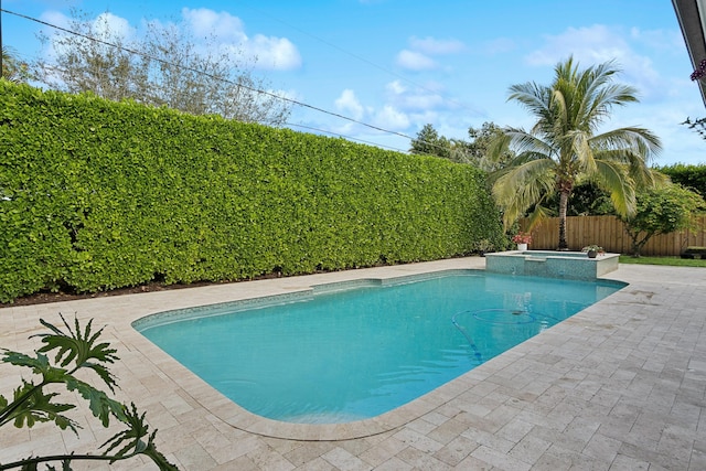 view of pool with a patio and an in ground hot tub